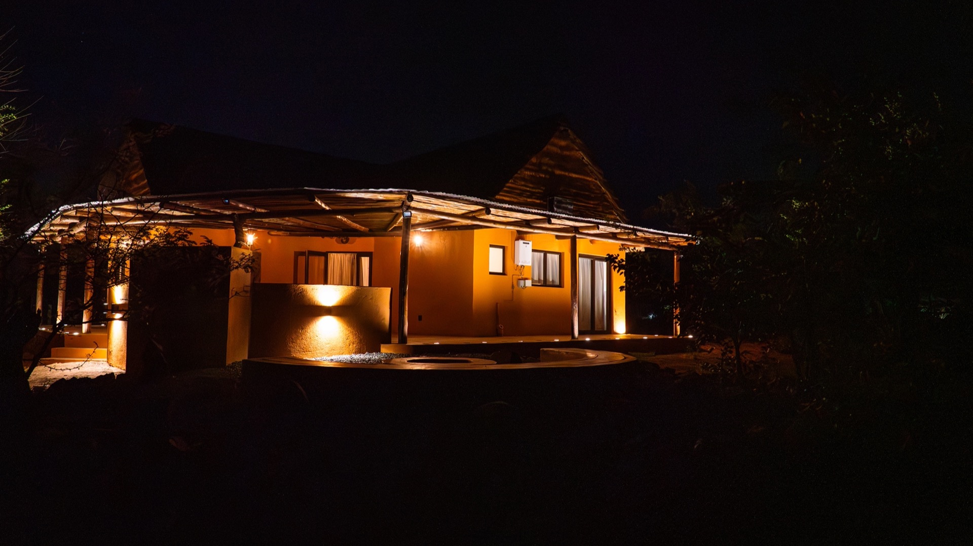 The villa's twin gables and round deck under a night sky